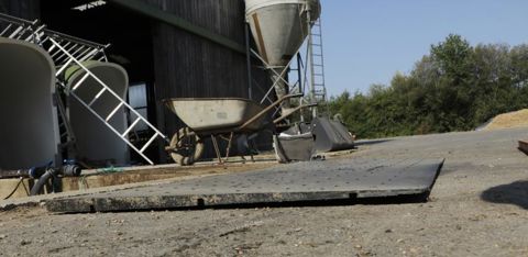 La surface du sol est constituée de pièces alvéolées en plastique léger qui forment une pente de 3 %, pour faire couler la partie la plus liquide des effluents vers la rainure où circule la courroie. © G. Baron