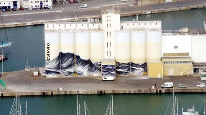 Une vague de 16 mètres de haut décore le silo du groupe Cavac aux Sables-d'Olonne en avant-première du Vendée Globe. © B. GERGAUD Une vague de 16 mètres de haut décore le silo du groupe Cavac aux Sables-d'Olonne en avant-première du Vendée Globe. © B. GERGAUD