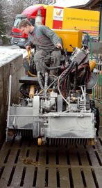 Deux rotors décalés travaillant sur 1 m de large. L'automoteur de rainurage des caillebotis fonctionne avec deux rotors décalés de 50 cm travaillant en ligne et tournant à 2 500 tr/ min (1 500 tr pour le rainurage des aires bétonnées). L'entraînement de ces deux rotors, comme l'avancement de la machine, se réalise grâce à des pompes hydrauliques. Chaque rotor est équipé de quinze groupes de trois disques diamant accolés. 