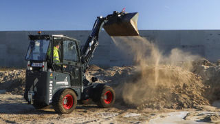 La chargeuse KM 180E équipée d'un bras télescopique peut basculer sa charge jusqu'à 3,31 m de hauteur.