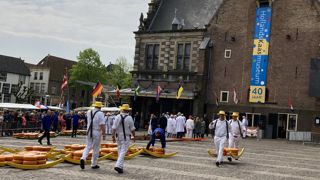Au marché de Alkmaar, les porteurs vêtus de blanc transportent 100 kg de fromages posés sur une « berrie ». Au marché de Alkmaar, les porteurs vêtus de blanc transportent 100 kg de fromages posés sur une « berrie ».